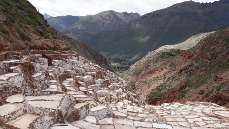 Discover Maras, a spectacle of white pools surrounded by mountains.